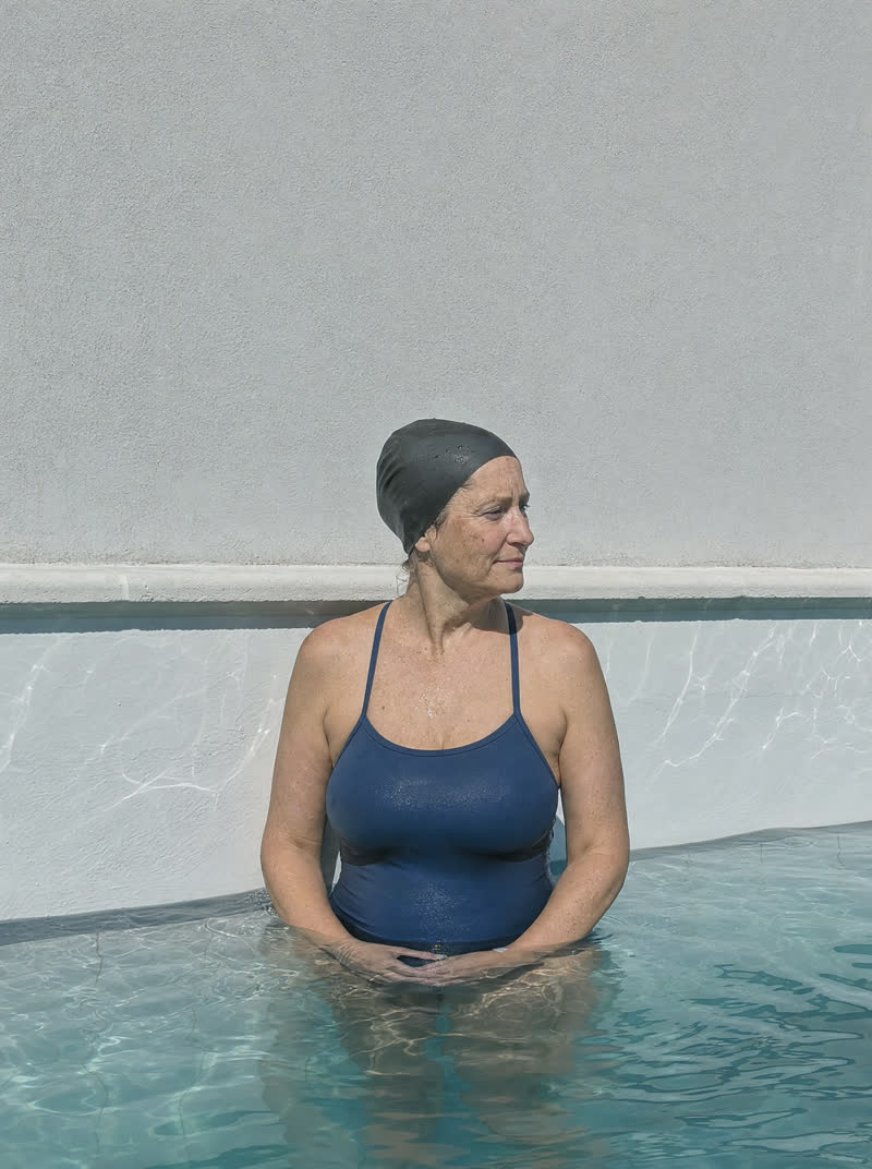 a girl at an outdoor pool in hard sun — the flat original